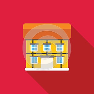 Yellow building facade with windows casting long shadow on red background