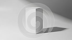 Minimalist white rectangular box on a white surface with dramatic shadow cube object