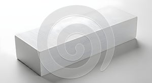 Minimalist white rectangular box on a white surface casting a shadow