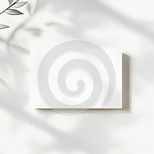 Minimalist white rectangular card with soft shadows in a bright, airy setting