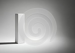 Minimalist white rectangular object with dramatic lighting and shadow
