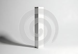 Minimalist white rectangular object with dramatic shadow on gray background