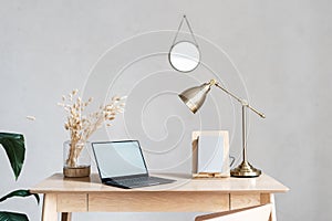 Minimalist workspace with laptop on wooden desk