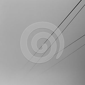 Minimalistic black and white image of cable way dissolving in a