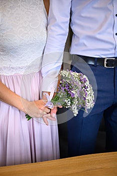 Minimalistic bridal bouquet at a wedding cerenomy, consisting of heather