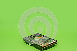 Minimalistic composition of 3.5 HDD on a green background. Mining on hard disk drive concept