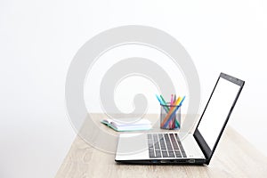 Minimalistic composition of workplace with laptop and stationery