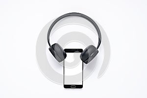 Minimalistic concept of gadgets for music lovers, smartphone with white screen with wireless headphones. layout for apps