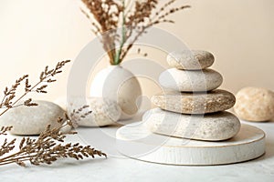 Empty stone stack podium on beige background