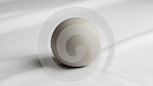The minimalistic setting emphasizes the sphere s shape and texture