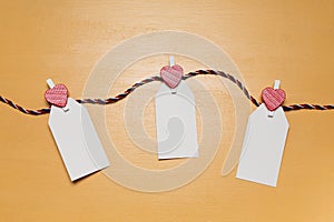 Minimalistic simple Valentine`s day concept, empty white cards for wishes with little red heart pins