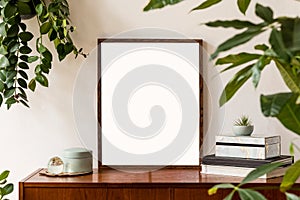 Minimalistic and stylish mock up poster frame concept with retro furnitures, hanging plant, decoration, book, air plant.