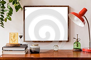 Minimalistic and stylish mock up poster frame concept with retro furnitures, hanging plant, table lamp, decoration.