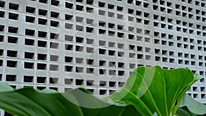 Minimalistic white brick wall pattern on clean iron mesh backdrop
