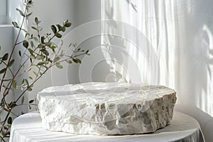 Minimalistic white stone podium with plants. Mock up for product, cosmetic presentation. Pedestal, platform for beauty