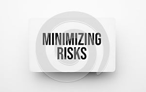 minimizing risks sign on notepad on the white backgound