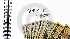 Minimum wage handwriting  text on paper, on office agenda. Copy space