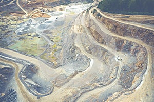 Mining from above. Industrial terraces on open pit  mineral mine. Aerial view of opencast mining. Dolomite Mine Excavation.