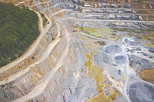Mining from above. Industrial terraces on open pit  mineral mine. Aerial view of opencast mining. Dolomite Mine Excavation.