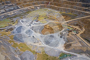 Mining from above. Industrial terraces on open pit  mineral mine. Aerial view of opencast mining. Dolomite Mine Excavation.