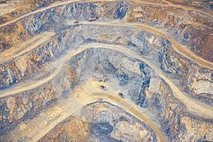 Mining from above. Industrial terraces on open pit  mineral mine. Aerial view of opencast mining. Dolomite Mine Excavation.