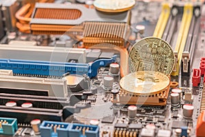 Mining btc crypto cash. Two bitcoin on radiator of desktop computer mainboard