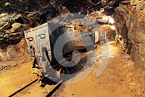 Mining cart in silver, gold, copper mine photo