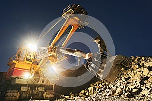 Mining construction industry. Excavator digging granite or ore in quarry