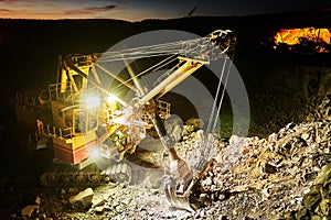 Mining construction industry. Excavator digging granite or ore in quarry photo