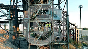 Mining construction in the port with two engineers standing in it