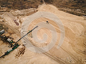 Mining conveyor at sand quarry. Aerial view of mining machinery