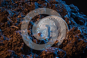 Mining crypto currency - Bitcoin. Online money coin in the dirt ground. Digital currency, block chain market, online business