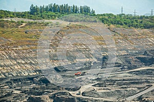 Mining dump trucks working in coalmine.