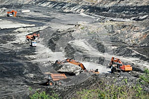 Mining dump trucks working in coalmine.