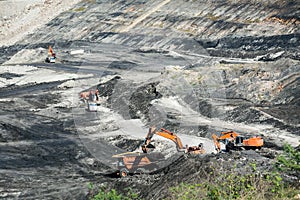 Mining dump trucks working in coalmine.