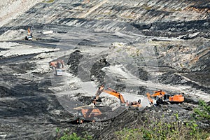 Mining dump trucks working in coalmine.