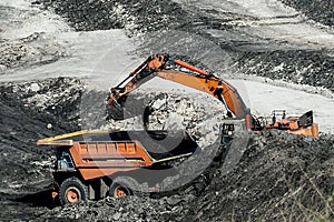 Mining dump trucks working in coalmine.