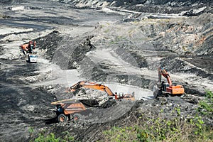 Mining dump trucks working in coalmine.