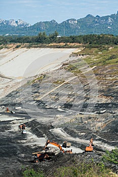 Mining dump trucks working in coalmine.
