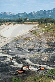 Mining dump trucks working in coalmine.