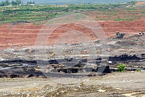 Mining dump trucks working in Lignite coalmine