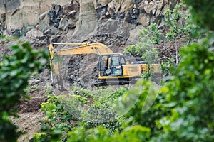 Mining by Excavator Backhoe Digger in Forest