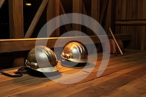 mining helmets with headlamps placed on a wooden table