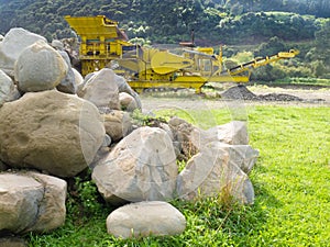Mining industry rock crusher in stone quarry pit photo