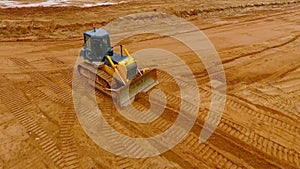 Mining machinery. Bulldozer machine. Aerial view of crawler bulldozer mine sand