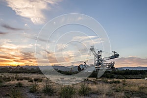 Mining machinery in a sunset