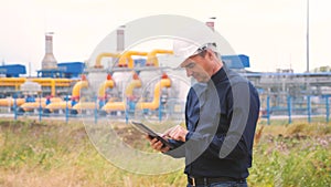 Mining oil gas production industry concept. Engineer man power and energy using lifestyle digital tablet. Worker a in