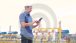 Mining oil gas production industry concept. engineer man power and energy using lifestyle digital tablet. worker in a
