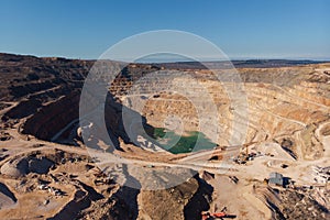 Mining quarry, aerial view. Industrial production and transportation of minerals, ore and gravel