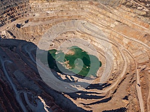 Mining quarry, aerial view. Industrial production and transportation of minerals, ore and gravel